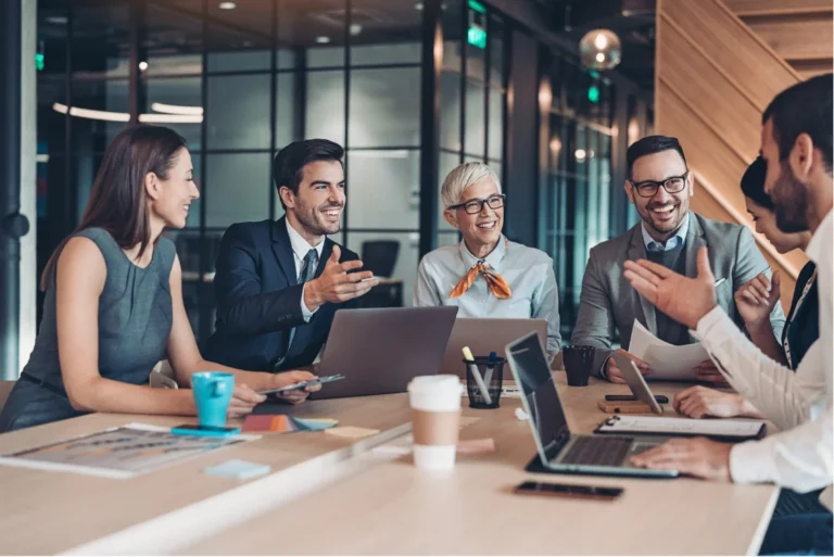 A diverse group of cheerful professionals engaged in a collaborative discussion