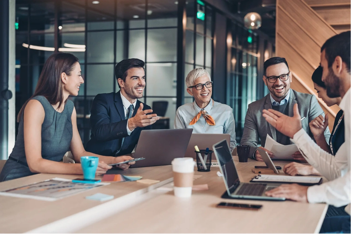 A diverse group of cheerful professionals engaged in a collaborative discussion